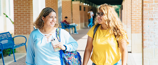 two female students walking on St. Philip's campus