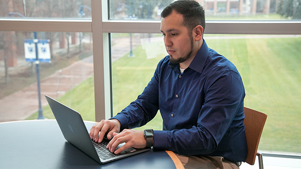 Male Student on his Laptop